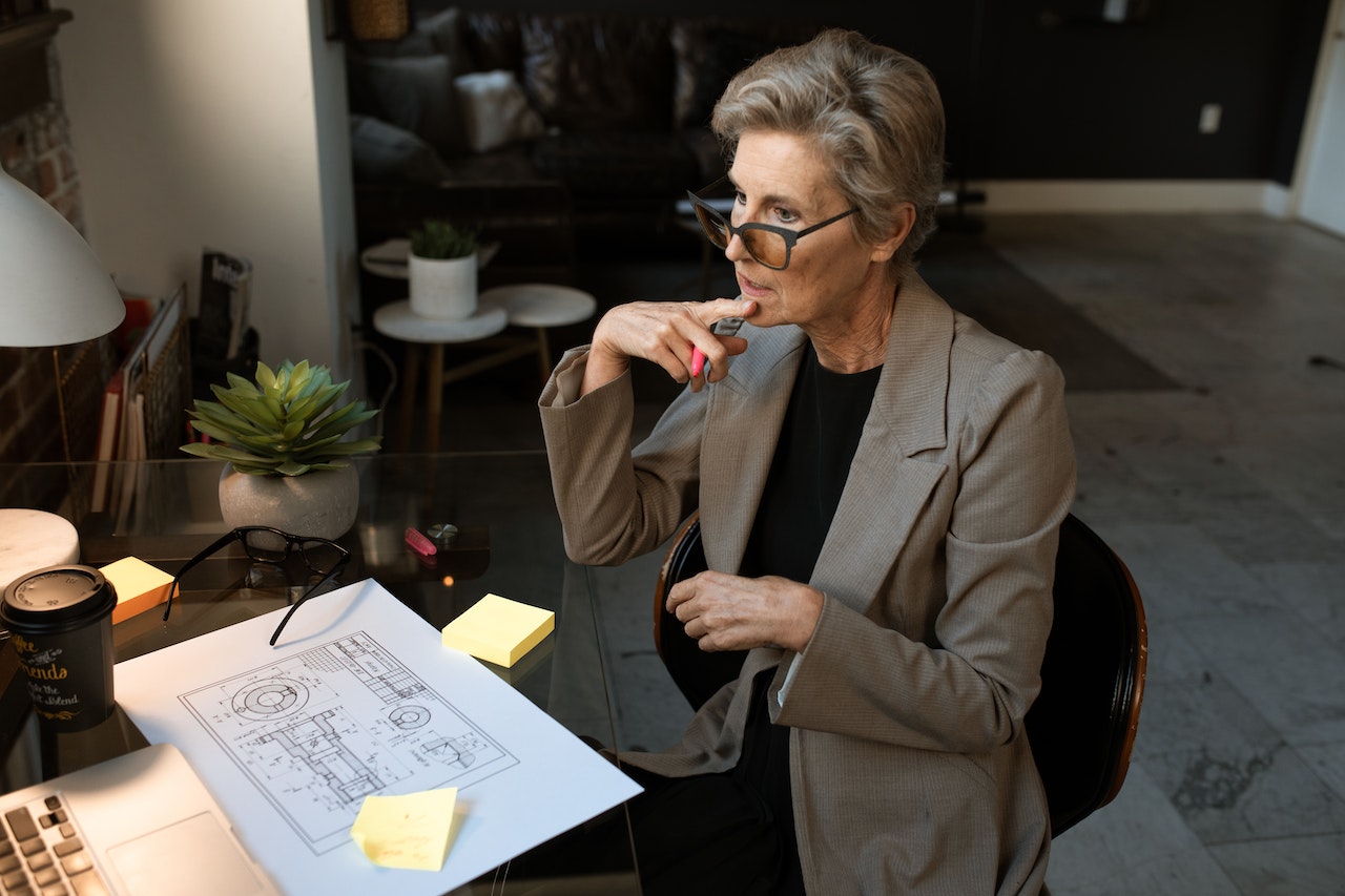 Takeoff Monkey blog article, The Future of the Construction Estimating Industry image: person sitting at a desk with construction plans in front of them